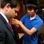 Orlando Sentinel videographer Sean Pitts mic'ing up Senator Marco Rubio.